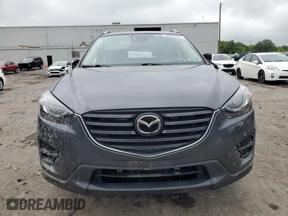 2016 Mazda CX-5 Grand Touring z VIN JM3KE4DY5G0741800, wystawiony jako Copart lot #58565455 z przebiegiem 33 675 mil mil oraz Szkoda całkowita • Salvage title. Historia ofert i sprzedaży dostępna na DreamBid. Obrazek 5.