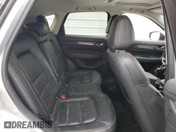 2021 Mazda CX-5 Grand Touring z VIN JM3KFADM7M1339081, wystawiony jako Copart lot #58913585 z przebiegiem Nie podano mil oraz Szkoda całkowita • Salvage title. Historia ofert i sprzedaży dostępna na DreamBid. Obrazek 11.