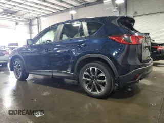 2016 Mazda CX-5 Grand Touring with VIN JM3KE4DY0G0826687, listed as a Copart auction lot 50886975 with 130,493 mi miles and Salvage Title. Bid and sale history available at carsss.com. Image 2.