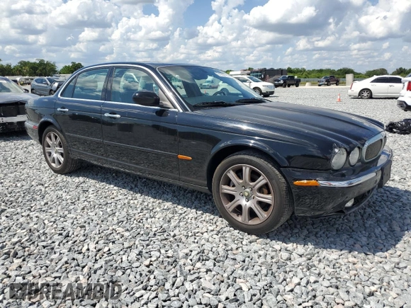 2004 Jaguar XJ with VIN SAJEA71C14SG10928, listed as a Copart auction lot 51202785 with 164,300 mi miles and Salvage Title. Bid and sale history available at carsss.com. Image 4.