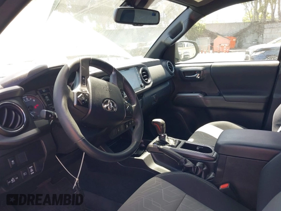 2023 Toyota Tacoma SR with VIN 3TMCZ5AN3PM590101, listed as a IAAI auction lot 42338670 with 12,970 mi miles and . Bid and sale history available at DreamBid. Image 6.