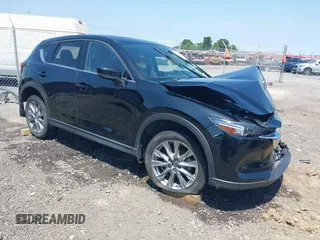 2020 Mazda CX-5 Grand Touring with VIN JM3KFADM9L1837183, listed as a IAAI auction lot 42340628 with 81,975 mi miles and . Bid and sale history available at DreamBid. Image 1.