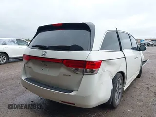 2014 Honda Odyssey Touring with VIN 5FNRL5H95EB059729, listed as a IAAI auction lot 42148110 with 135,304 mi miles and . Bid and sale history available at DreamBid. Image 4.