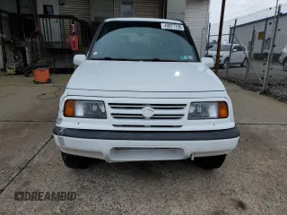 1996 Suzuki Sidekick JX z VIN 2S3TD03V7T6409487, wystawiony jako Copart lot #49977795 z przebiegiem 137 011 mil mil oraz Szkoda całkowita • Salvage title. Historia ofert i sprzedaży dostępna na DreamBid. Obrazek 5.