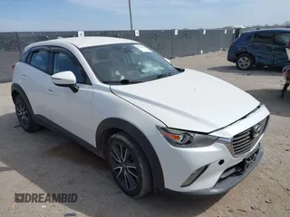 2018 Mazda CX-3 Touring z VIN JM1DKDC75J0326180, wystawiony jako IAAI lot #41787541 z przebiegiem 96 584 mil mil oraz . Historia ofert i sprzedaży dostępna na DreamBid. Obrazek 1.