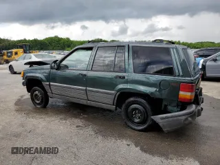1995 Jeep Grand Cherokee Laredo with VIN 1J4FX58S8SC773884, listed as a Copart auction lot 56572555 with 424,126 mi miles and Salvage title. Bid and sale history available at DreamBid. Image 2.