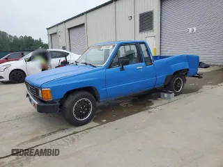 1984 Toyota Pickup z VIN JT4RN56S7E0022485, wystawiony jako Copart lot #53792665 z przebiegiem 204 323 mil mil oraz Szkoda całkowita • Salvage title. Historia ofert i sprzedaży dostępna na DreamBid. Obrazek 1.