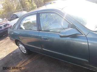 1998 Mazda 626 DX with VIN 1YVGF22C4W5768778, listed as a IAAI auction lot 41971066 with 119,168 mi miles. Bid and sale history available at carsss.com. Image 13.