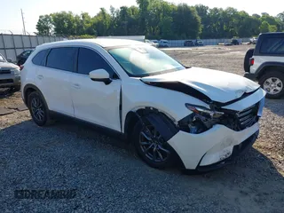 2021 Mazda CX-9 Sport z VIN JM3TCABY1M0501408, wystawiony jako IAAI lot #42257940 z przebiegiem 62 228 mil mil oraz . Historia ofert i sprzedaży dostępna na DreamBid. Obrazek 1.