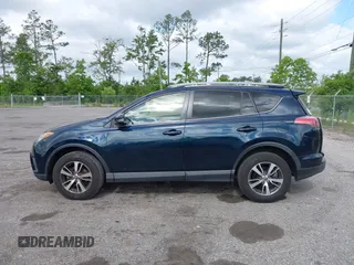 2018 Toyota RAV4 XLE with VIN JTMWFREV9JJ165655, listed as a IAAI auction lot 42138998 with 123,569 mi miles and . Bid and sale history available at carsss.com. Image 14.