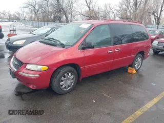 1999 Chrysler Town & Country with VIN 1C4GT64L7XB723937, listed as a IAAI auction lot 41609957 with 242,800 mi miles and . Bid and sale history available at DreamBid. Image 2.