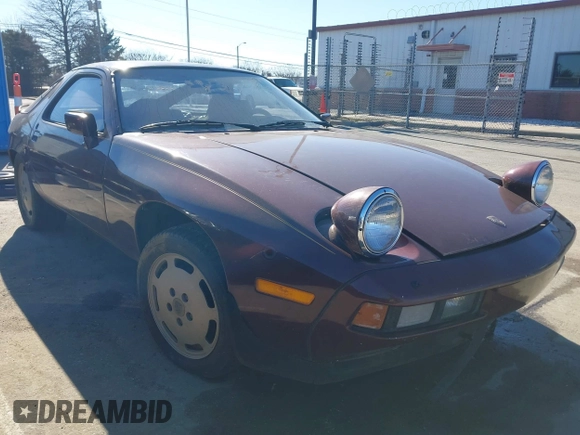 1984 Porsche 928 z VIN WP0JB0925ES860300, wystawiony jako IAAI lot #41581309 z przebiegiem 115 151 mil mil oraz . Historia ofert i sprzedaży dostępna na DreamBid. Obrazek 1.