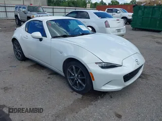 2020 Mazda MX-5 Miata Grand Touring z VIN JM1NDAM79L0411456, wystawiony jako IAAI lot #42229479 z przebiegiem 63 508 mil mil oraz . Historia ofert i sprzedaży dostępna na DreamBid. Obrazek 1.
