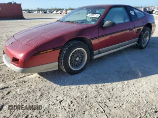 1987 Pontiac Fiero GT z VIN 1G2PG1195HP233666, wystawiony jako Copart lot #78981714 z przebiegiem Nie podano mil oraz Szkody całkowita. Historia ofert i sprzedaży dostępna na DreamBid. Obrazek 1.