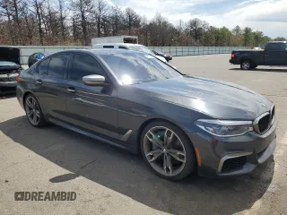 2018 BMW 5 Series M550i xDrive with VIN WBAJB9C57JB286734, listed as a Copart auction lot 52711235 with 127,450 mi miles and Salvage title. Bid and sale history available at DreamBid. Image 4.