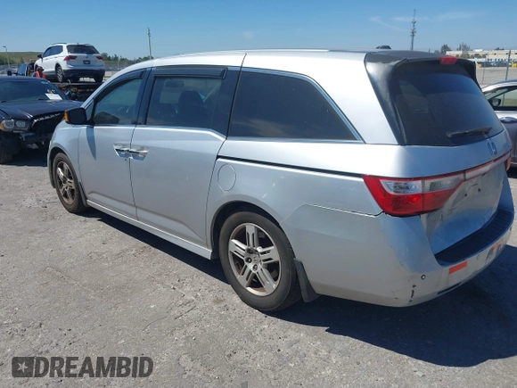 2012 Honda Odyssey Touring with VIN 5FNRL5H90CB099519, listed as a IAAI auction lot 41854550 with 185,110 mi miles. Bid and sale history available at carsss.com. Image 3.