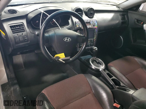 2006 Hyundai Tiburon GT z VIN KMHHN65F96U203924, wystawiony jako Copart lot #43624185 z przebiegiem 120 403 mil mil oraz Szkoda całkowita • Salvage title. Historia ofert i sprzedaży dostępna na DreamBid. Obrazek 8.