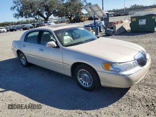 2001 Lincoln Town Car Cartier z VIN 1LNHM83W31Y671814, wystawiony jako Copart lot #77169664 z przebiegiem Nie podano mil oraz Szkoda całkowita • Salvage title. Historia ofert i sprzedaży dostępna na DreamBid. Obrazek 4.