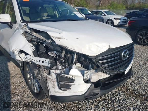 2016 Mazda CX-5 Sport with VIN JM3KE2BY2G0819604, listed as a IAAI auction lot 42059846 with 124,911 mi miles. Bid and sale history available at carsss.com. Image 6.