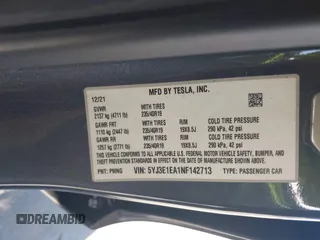 2022 Tesla Model 3 with VIN 5YJ3E1EA1NF142713, listed as a IAAI auction lot 42027630 with 112,557 mi miles. Bid and sale history available at carsss.com. Image 9.