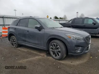 2016 Mazda CX-5 Grand Touring z VIN JM3KE2DY9G0687261, wystawiony jako Copart lot #52865415 z przebiegiem Nie podano mil oraz Szkoda całkowita • Salvage title. Historia ofert i sprzedaży dostępna na DreamBid. Obrazek 4.