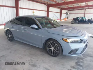2022 Honda Civic Touring with VIN 2HGFE1F90NH308457, listed as a IAAI auction lot 42592841 with 126,987 mi miles and . Bid and sale history available at DreamBid. Image 1.