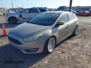 2015 Ford Focus SE with VIN 1FADP3K23FL261021, listed as a IAAI auction lot 42014802 with 157,283 mi miles. Bid and sale history available at carsss.com. Image 2.
