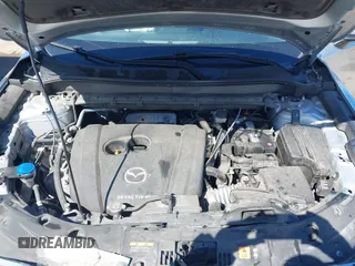 2021 Mazda CX-5 Grand Touring with VIN JM3KFBDM3M1300316, listed as a IAAI auction lot 41878520 with 77,670 mi miles and . Bid and sale history available at DreamBid. Image 10.