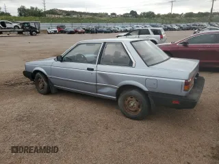 1987 Nissan Sentra z VIN JN1PB2210HU557007, wystawiony jako Copart lot #68174784 z przebiegiem 150 316 mil mil oraz Tytuł czysty. Historia ofert i sprzedaży dostępna na DreamBid. Obrazek 2.