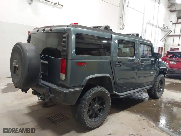 2005 Hummer H2 SUV with VIN 5GRGN23U65H132505, listed as a IAAI auction lot 41515346 with 140,944 mi miles. Bid and sale history available at carsss.com. Image 4.