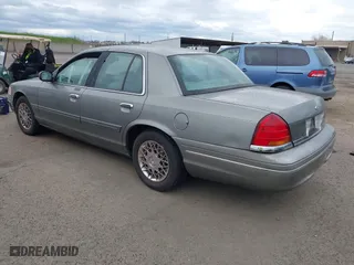1999 Ford Crown Victoria LX with VIN 2FAFP74W4XX192490, listed as a IAAI auction lot 41791909 with 115,469 mi miles. Bid and sale history available at carsss.com. Image 3.