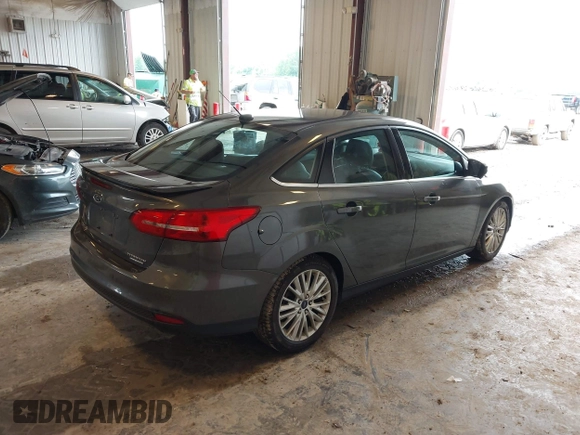 2015 Ford Focus Titanium z VIN 1FADP3J22FL260718, wystawiony jako IAAI lot #42545411 z przebiegiem 83 518 mil mil oraz . Historia ofert i sprzedaży dostępna na DreamBid. Obrazek 4.
