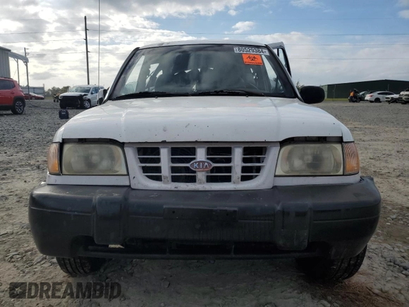 1999 Kia Sportage with VIN KNDJA7233X5600719, listed as a Copart auction lot 80529384 with 56,657 mi miles and Salvage Title. Bid and sale history available at carsss.com. Image 5.