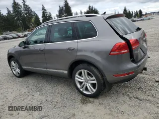 2012 Volkswagen Touareg Sport with VIN WVGFK9BP4CD001860, listed as a Copart auction lot 55090375 with 153,456 mi miles and Salvage title. Bid and sale history available at DreamBid. Image 2.