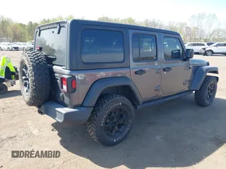 2021 Jeep Wrangler Unlimited Willys with VIN 1C4HJXDG1MW672507, listed as a IAAI auction lot 42084805 with 59,943 mi miles and . Bid and sale history available at DreamBid. Image 4.