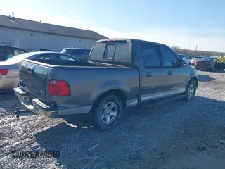 2003 Ford F-150 XLT with VIN 1FTRW07L13KB66977, listed as a IAAI auction lot 41967541 with 124,714 mi miles. Bid and sale history available at carsss.com. Image 4.