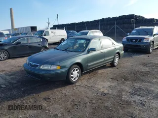 1999 Mazda 626 ES with VIN 1YVGF22C0X5835930, listed as a IAAI auction lot 41666820 with 93,973 mi miles. Bid and sale history available at carsss.com. Image 2.