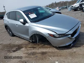 2020 Mazda CX-5 Touring with VIN JM3KFACM9L0785464, listed as a IAAI auction lot 42023311 with 90,062 mi miles and . Bid and sale history available at DreamBid. Image 1.