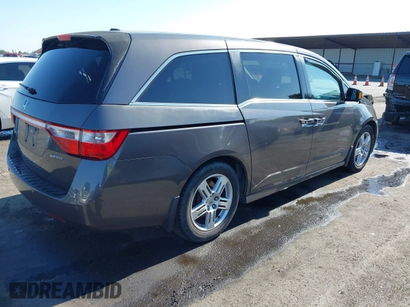 2012 Honda Odyssey Touring with VIN 5FNRL5H95CB057346, listed as a IAAI auction lot 42644094 with 114,712 mi miles and . Bid and sale history available at DreamBid. Image 4.