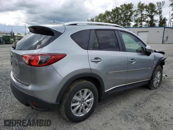 2014 Mazda CX-5 Touring z VIN JM3KE4CY0E0407169, wystawiony jako Copart lot #57877215 z przebiegiem 168 277 mil mil oraz Szkoda całkowita • Salvage title. Historia ofert i sprzedaży dostępna na DreamBid. Obrazek 3.