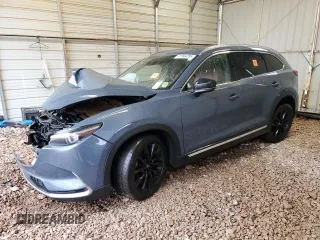 2021 Mazda CX-9 Carbon Edition z VIN JM3TCADY0M0501090, wystawiony jako Copart lot #47944285 z przebiegiem Nie podano mil oraz Szkoda całkowita • Salvage title. Historia ofert i sprzedaży dostępna na DreamBid. Obrazek 1.