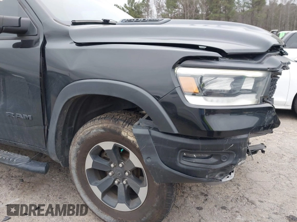 2019 Ram 1500 Rebel z VIN 1C6SRFLT1KN722064, wystawiony jako IAAI lot #41513201 z przebiegiem 113 559 mil mil oraz . Historia ofert i sprzedaży dostępna na DreamBid. Obrazek 19.