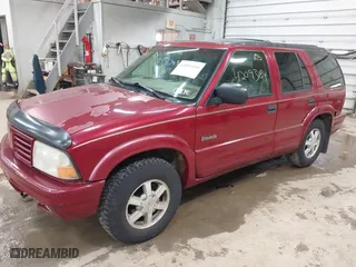 1999 Oldsmobile Bravada with VIN 1GHDT13W9X2701952, listed as a IAAI auction lot 42093184 with 121,532 mi miles. Bid and sale history available at carsss.com. Image 2.