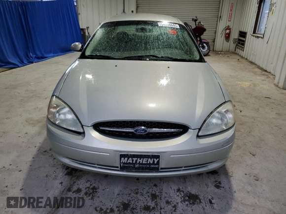 2003 Ford Taurus SE Standard z VIN 1FAFP532X3A195612, wystawiony jako Copart lot #54016645 z przebiegiem 143 168 mil mil oraz Szkoda całkowita • Salvage title. Historia ofert i sprzedaży dostępna na DreamBid. Obrazek 5.