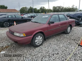 1991 Toyota Camry DLX z VIN 4T1SV21E0MU450578, wystawiony jako Copart lot #73990024 z przebiegiem 149 342 mil mil oraz Czysty tytuł • Clean title. Historia ofert i sprzedaży dostępna na DreamBid. Obrazek 1.