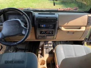 1999 Jeep Wrangler Sahara with VIN 1J4FY49S5XP496486, listed as a Copart auction lot 77263014 with 128,498 mi miles and Clean Title. Bid and sale history available at carsss.com. Image 9.