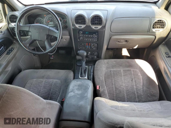 2003 GMC Envoy SLT z VIN 1GKDS13S032373020, wystawiony jako Copart lot #54986765 z przebiegiem 235 711 mil mil oraz Tytuł czysty. Historia ofert i sprzedaży dostępna na DreamBid. Obrazek 8.