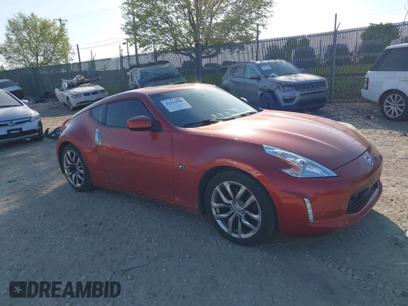 2014 Nissan 370Z Nismo with VIN JN1AZ4EH9EM636340, listed as a IAAI auction lot 42112548 with 143,894 mi miles and . Bid and sale history available at DreamBid. Image 1.
