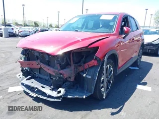 2016 Mazda CX-5 Grand Touring z VIN JM3KE2DY2G0660385, wystawiony jako IAAI lot #42101004 z przebiegiem 166 336 mil mil oraz . Historia ofert i sprzedaży dostępna na DreamBid. Obrazek 2.