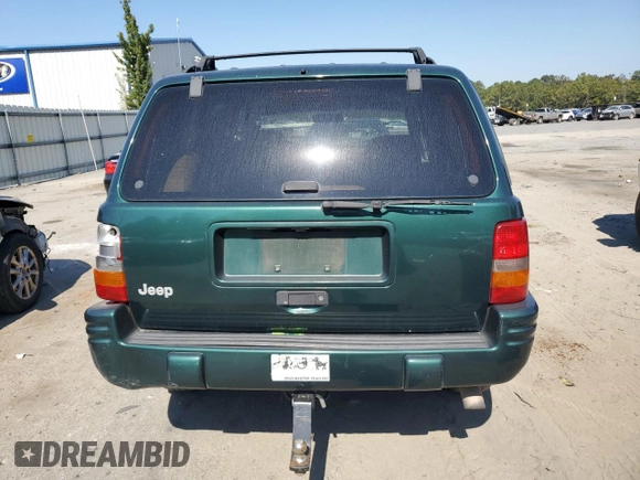 1998 Jeep Grand Cherokee with VIN 1J4FX48S8WC281615, listed as a Copart auction lot 77305594 with 128,393 mi miles and Salvage title. Bid and sale history available at DreamBid. Image 6.